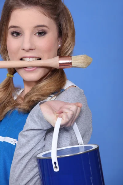 Retrato de lindo pintor rubio sosteniendo cepillo entre dientes contra ba azul —  Fotos de Stock
