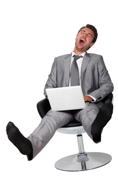 Negócios com computador bocejando — Fotografia de Stock