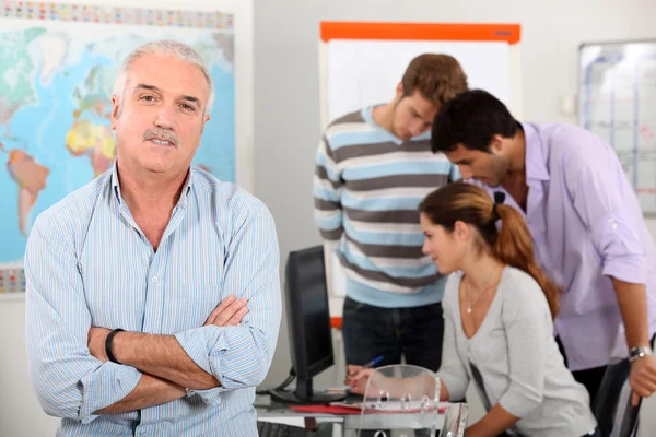 Teacher with a group of mature students — Stock Photo, Image