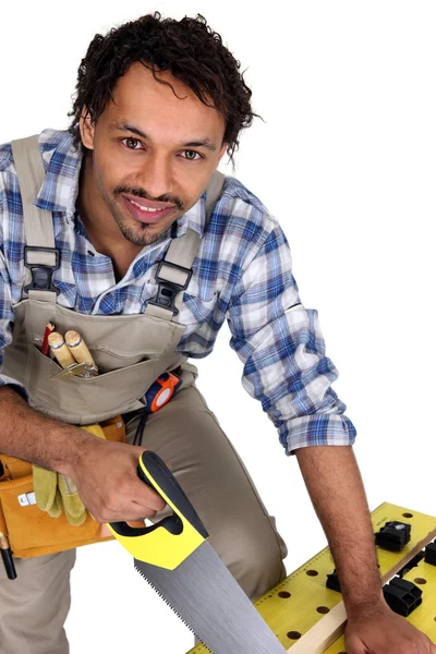 Tradesman sawing a piece of wood Stock Picture