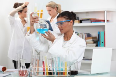 Three woman in science laboratory clipart