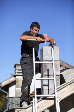 Builder constructing a chimney clipart