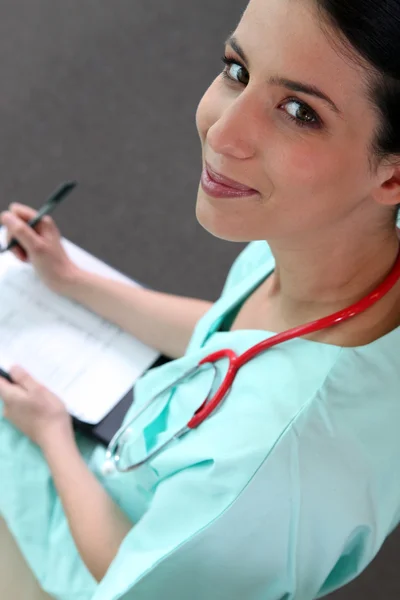 Female doctor taking notes — Stock Photo, Image