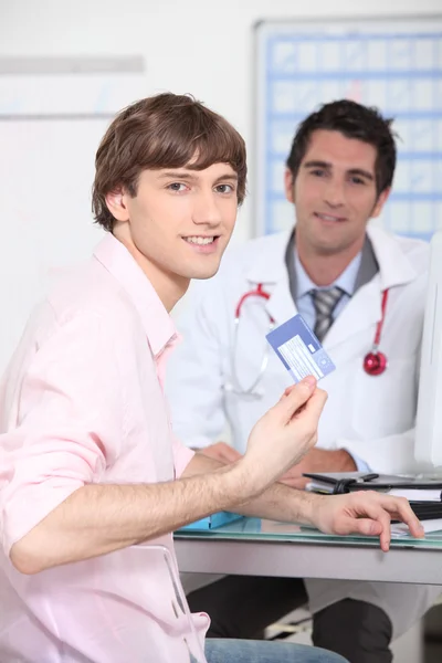 Young person showing European health card — Stock Photo, Image
