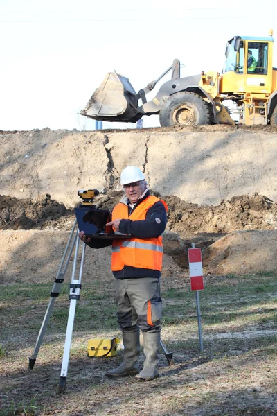 Surveyor werken op een bouwplaats — Stockfoto
