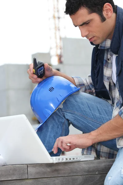 Foreman with radio and computer — Stock Photo, Image