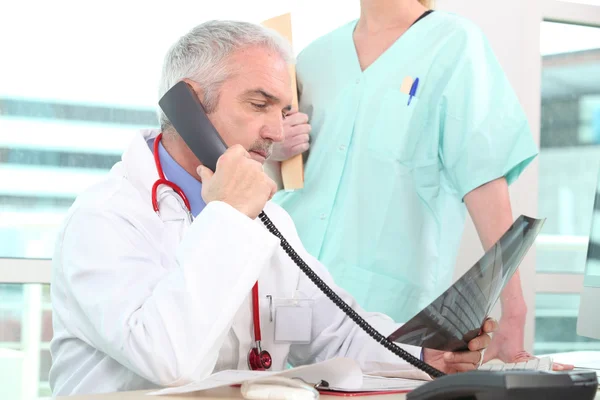 Senior doctor having a phone call — Stock Photo, Image