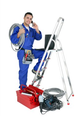 Electrician with mobile telephone clipart