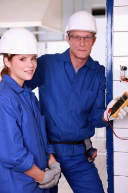 Young female apprentice electrician clipart