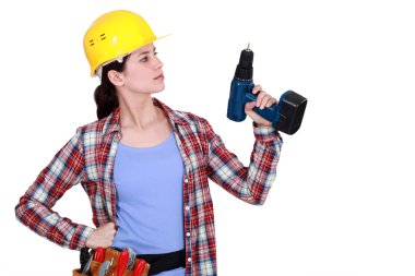 Tradeswoman holding up her electric screwdriver clipart