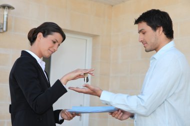 New property owner receiving the keys to his property clipart