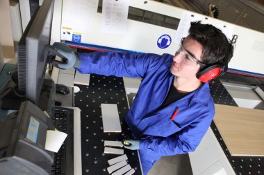 Young man working in a warehouse clipart