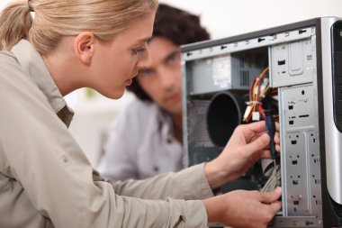 Woman fixing a computer hard drive clipart