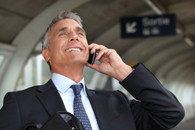 Portrait of a businessman on the phone clipart