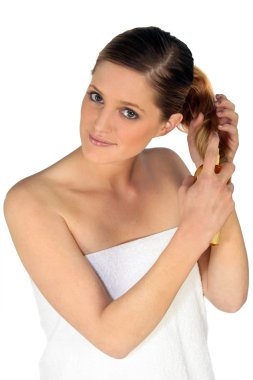 Woman taking care of her hair clipart