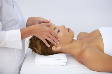 Woman being given head-massage clipart