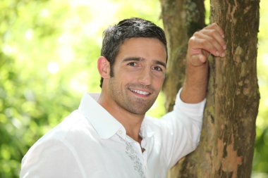 Portrait of a man next to a tree clipart