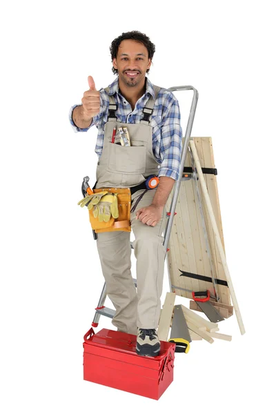 Cabinetmaker thumb up with foot resting on toolcase — Stock Photo, Image