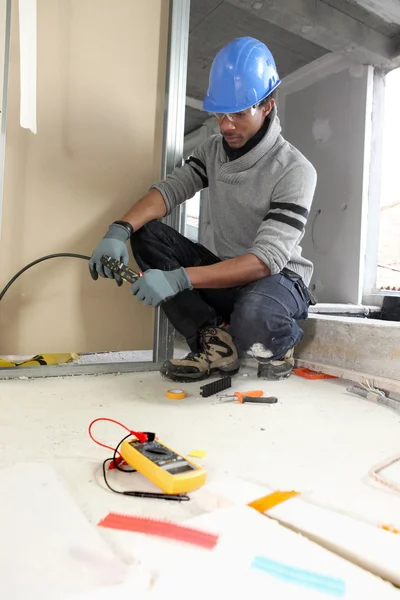 Black electrician at work — Stock Photo, Image