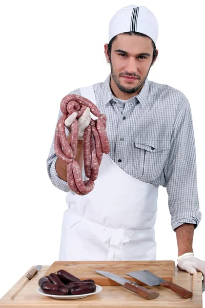 Butcher with sausages and black pudding — Stock Photo, Image