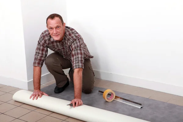 Man laying carpet — Stock Photo, Image