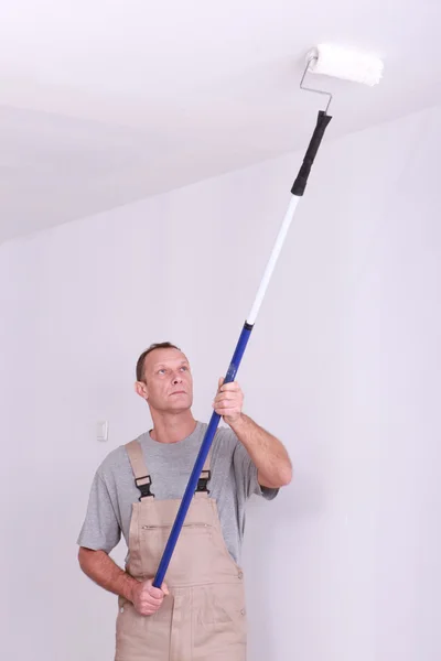 Man repainting ceiling — Stock Photo, Image