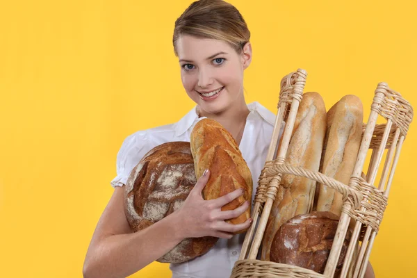 Bäckereiangestellte hält Korb — Stockfoto