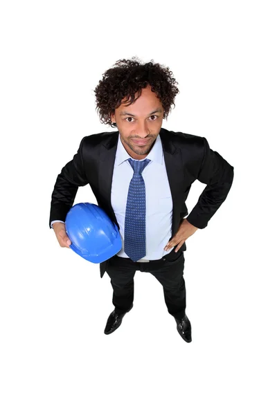 Smart entrepreneur holding hardhat — Stock Photo, Image