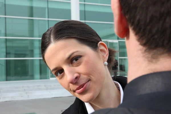 Affärskvinna som tittar över axeln kollegor — Stockfoto