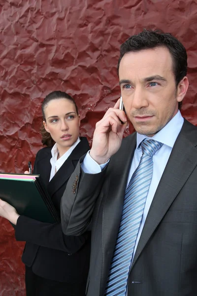 A manager at phone and his assistant — Stock Photo, Image