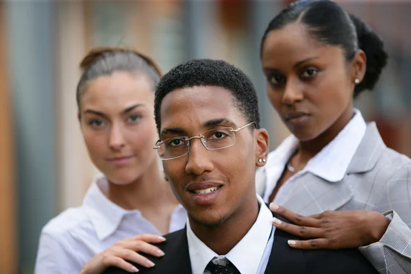 Women touching the shoulder of a man — Stock Photo, Image