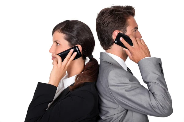 Businessman and businesswoman telephoning — Stock Photo, Image