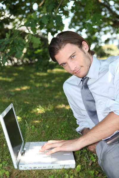 Relaxed businessman on the grass — Stock Photo, Image
