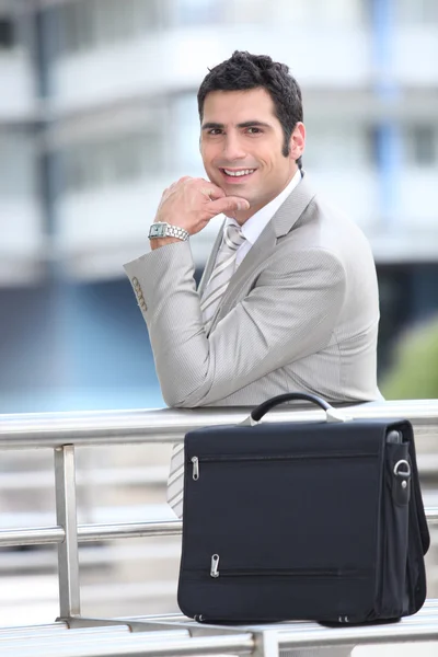 Улыбающийся бизнесмен и портфель — стоковое фото