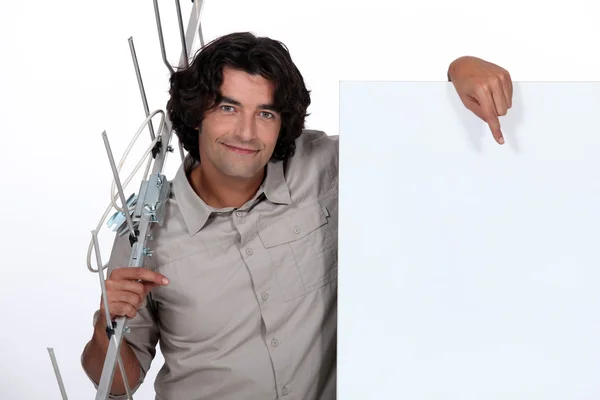 Man with a blank poster and an antenna — Stock Photo, Image