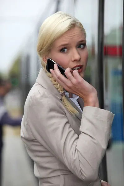 Mulher loira ao telefone com uma expressão facial ansiosa — Fotografia de Stock