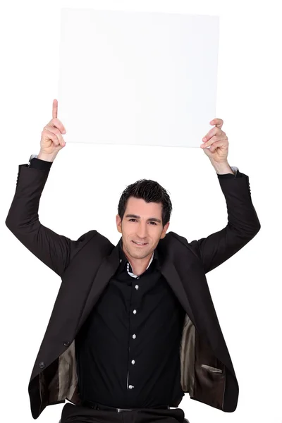 Ein Mann zeigt ein weißes Panel — Stockfoto