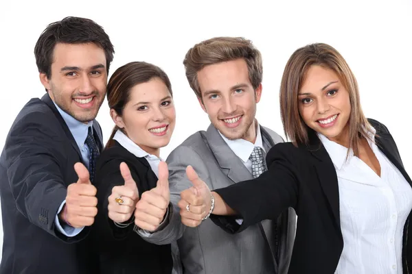 Quatro jovens profissionais dando os polegares para cima — Fotografia de Stock