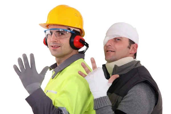 A construction worker and his injured colleague. — Stock Photo, Image