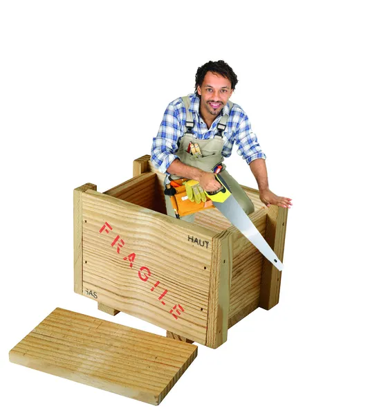 Carpenter with saw stood in wooden box — Stock Photo, Image