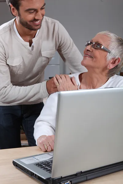 Syn pomáhat matce na laptop — Stock fotografie