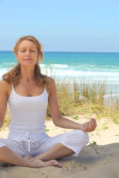 Mujer meditando en la playa —  Fotos de Stock