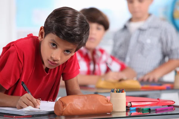 Little boy working in a classroom — Stock Photo, Image