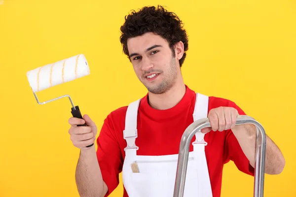 Decorator with a paint roller Royalty Free Stock Photos