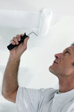 Decorator repainting ceiling clipart