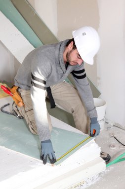 Man installing wall panels clipart