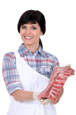 A butcher displaying a cut of meat clipart