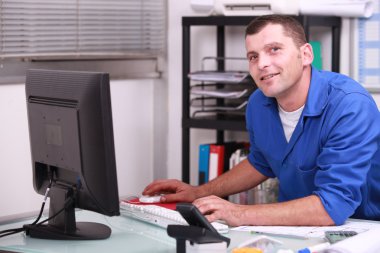 Factory worker in his office clipart