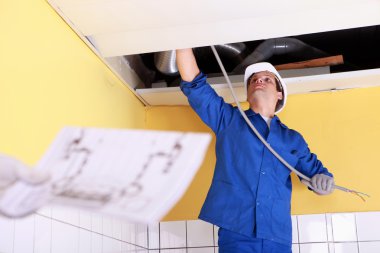 Worker fixing some electrical wires clipart