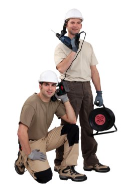 Tradesmen posing with their tools clipart